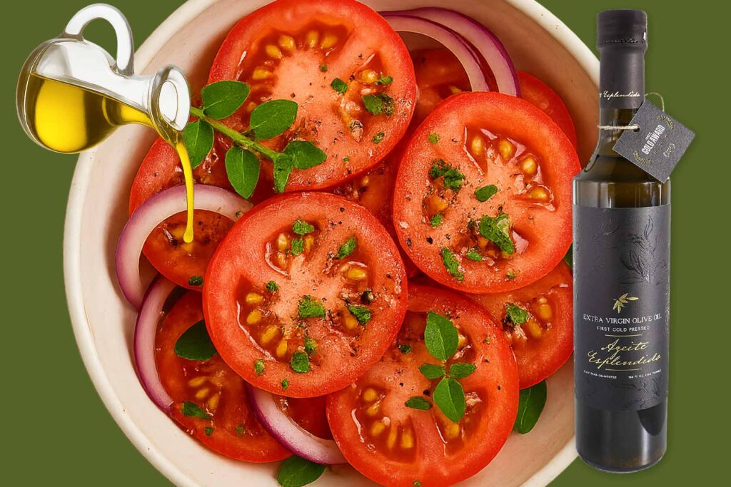 Plate of ripe, red tomatos and onion salad with cruet of olive oil and image of Esplendido olive oil