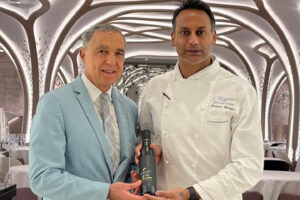 Jorge Caeiro and ChefKamlesh Koonjee standing holding a bottle of Esplendido Douro Extra Virgin Olive Oil